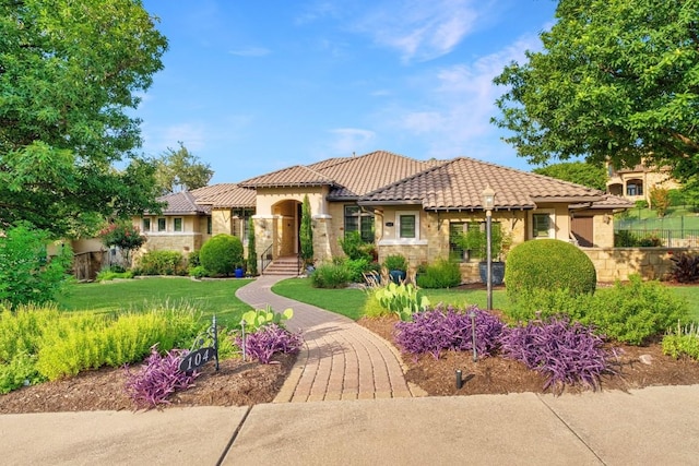104 Porto Cima Ct, Austin, TX 78738 - mediterranean / spanish house with stone siding, a front yard, a tile roof, and stucco siding
