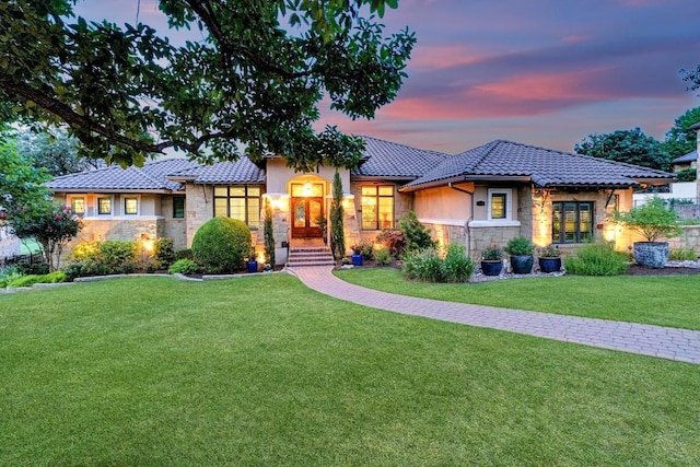 104 Porto Cima Ct, Austin, TX 78738 - view of front facade with stone siding, a yard, a tile roof, and stucco siding