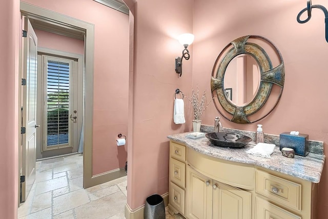 104 Porto Cima Ct, Austin, TX 78738 - bathroom featuring baseboards, stone tile flooring, and vanity