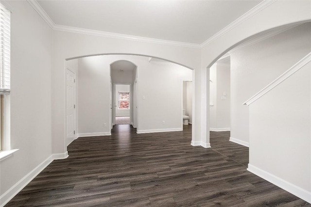 111 Colthorpe Ln, Hutto, TX 78634 - unfurnished room featuring arched walkways, dark wood-style floors, crown molding, and baseboards