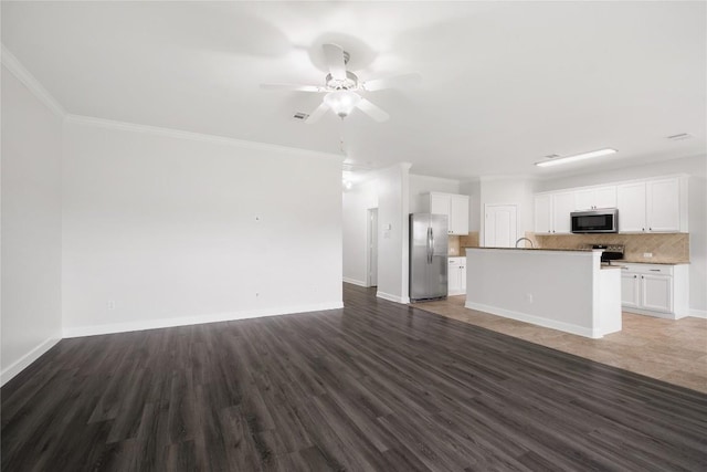 111 Colthorpe Ln, Hutto, TX 78634 - unfurnished living room featuring dark wood-style floors, ceiling fan, baseboards, and ornamental molding