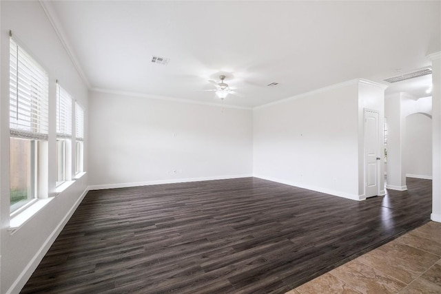 111 Colthorpe Ln, Hutto, TX 78634 - spare room featuring a ceiling fan, ornamental molding, baseboards, dark wood-type flooring, and arched walkways