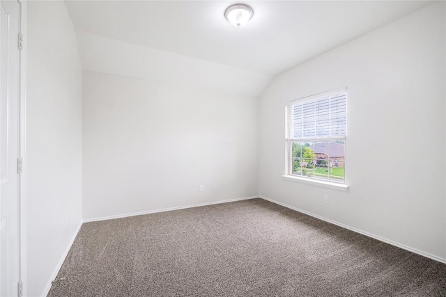 111 Colthorpe Ln, Hutto, TX 78634 - spare room featuring carpet flooring, vaulted ceiling, and baseboards