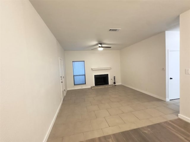 5504 Montview St, Austin, TX 78756 - unfurnished living room with a fireplace with raised hearth and ceiling fan