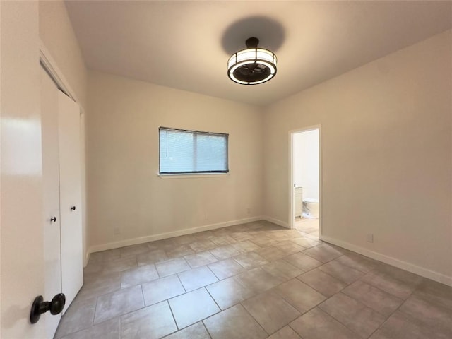 5504 Montview St, Austin, TX 78756 - unfurnished bedroom with a closet, tile patterned flooring, and ensuite bath