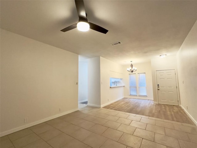 5504 Montview St, Austin, TX 78756 - empty room featuring a ceiling fan, a chandelier, and tile patterned flooring