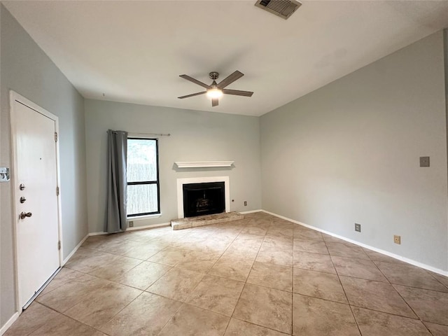 5504 Montview St, Austin, TX 78756 - unfurnished living room with a ceiling fan, a fireplace with raised hearth, and light tile patterned floors