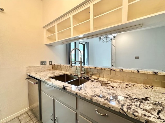 5504 Montview St, Austin, TX 78756 - kitchen featuring gray cabinetry, stainless steel dishwasher, light stone countertops, and open shelves
