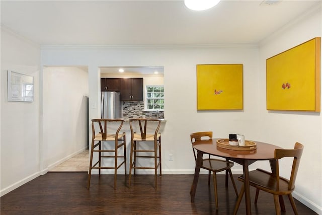 605 Orland Blvd, Austin, TX 78745 - dining space featuring ornamental molding, wood finished floors, and baseboards