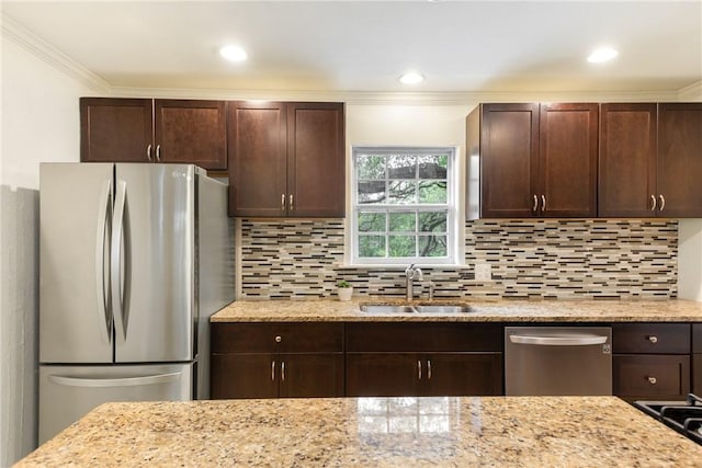 605 Orland Blvd, Austin, TX 78745 - kitchen featuring appliances with stainless steel finishes, a sink, dark brown cabinetry, backsplash, and ornamental molding