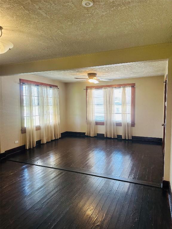 486 E Galveston St, Giddings, TX 78942 - unfurnished room with hardwood / wood-style floors, a textured ceiling, baseboards, and ceiling fan