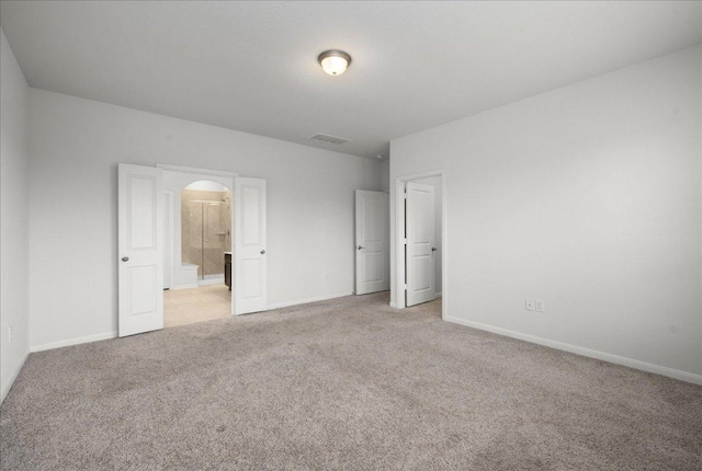423 Leadtree Loop, Buda, TX 78610 - unfurnished bedroom featuring light colored carpet and arched walkways