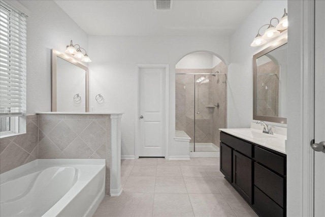 423 Leadtree Loop, Buda, TX 78610 - full bathroom with a garden tub, a shower stall, vanity, and tile patterned flooring
