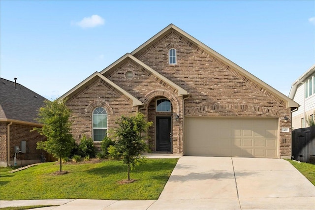 423 Leadtree Loop, Buda, TX 78610 - view of front of home featuring brick siding, driveway, and a front lawn
