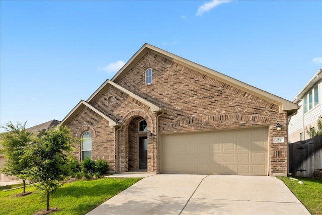 423 Leadtree Loop, Buda, TX 78610 - view of front facade featuring brick siding, driveway, and an attached garage