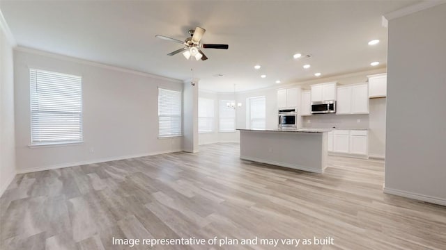 210 Dewey Dr, Killeen, TX 76542 - kitchen with stainless steel microwave, ornamental molding, a chandelier, ceiling fan, and white cabinetry