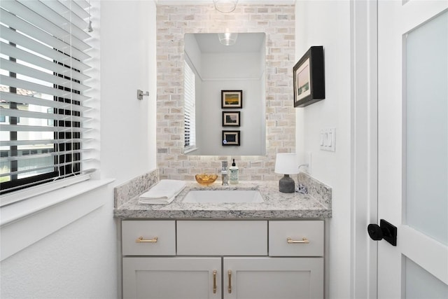 208 Honey Creek Ct Unit 29, Austin, TX 78738 - bathroom featuring vanity and tasteful backsplash
