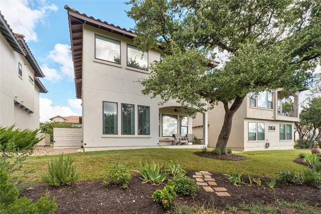 208 Honey Creek Ct Unit 29, Austin, TX 78738 - back of property with a ceiling fan, stucco siding, a yard, and a patio area