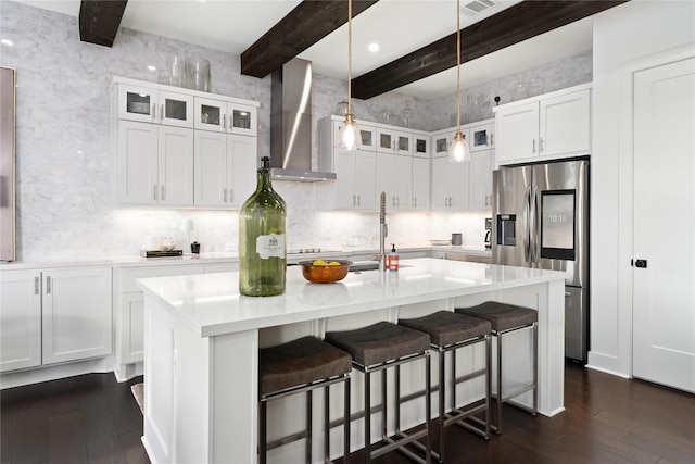 208 Honey Creek Ct Unit 29, Austin, TX 78738 - kitchen featuring stainless steel refrigerator with ice dispenser, wall chimney range hood, dark wood-style floors, beam ceiling, and light countertops