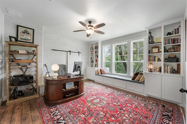 3205 River Place Dr Unit B, Belton, TX 76513 - home office featuring a barn door, a ceiling fan, and wood finished floors