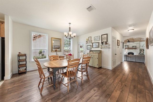 3205 River Place Dr Unit B, Belton, TX 76513 - dining room featuring wood-type flooring, a chandelier, and a fireplace