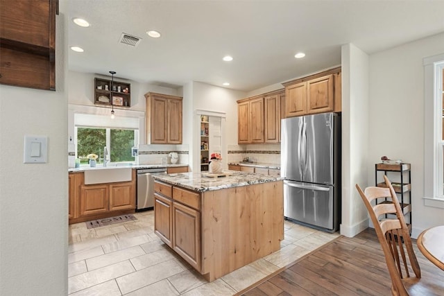 3205 River Place Dr Unit B, Belton, TX 76513 - kitchen with stainless steel appliances, a sink, recessed lighting, tasteful backsplash, and a center island