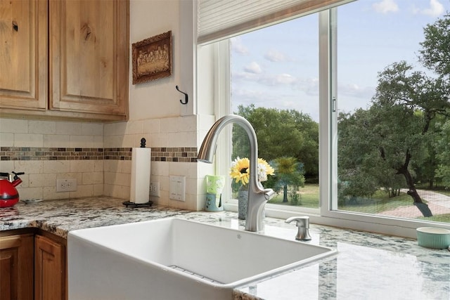 3205 River Place Dr Unit B, Belton, TX 76513 - kitchen with a sink, healthy amount of natural light, decorative backsplash, and light stone countertops