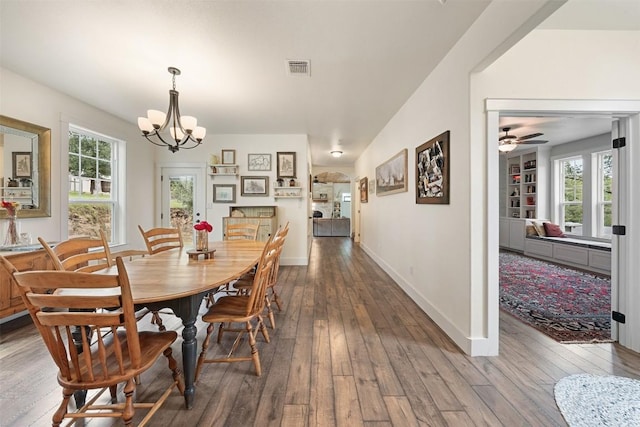 3205 River Place Dr Unit B, Belton, TX 76513 - dining area with wood-type flooring, ceiling fan, a chandelier, baseboards, and arched walkways