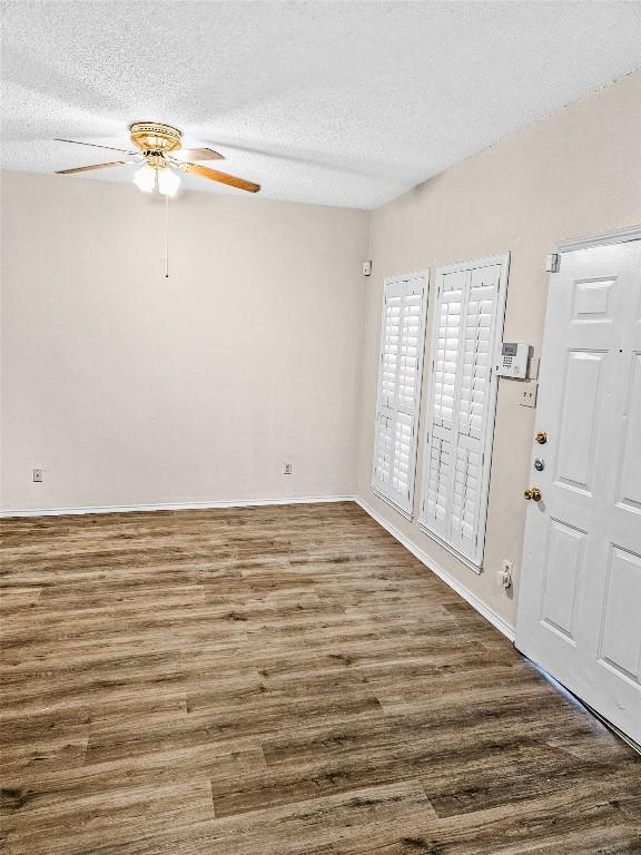 2706 Salado St Unit 205, Austin, TX 78705 - entrance foyer featuring ceiling fan, wood finished floors, a textured ceiling, and baseboards