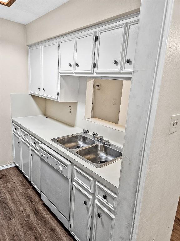 2706 Salado St Unit 205, Austin, TX 78705 - kitchen featuring dishwasher, dark wood-type flooring, light countertops, and white cabinetry