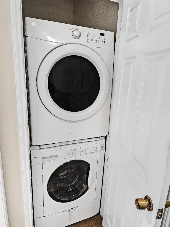 2706 Salado St Unit 205, Austin, TX 78705 - laundry room with stacked washer / drying machine and dark wood-type flooring