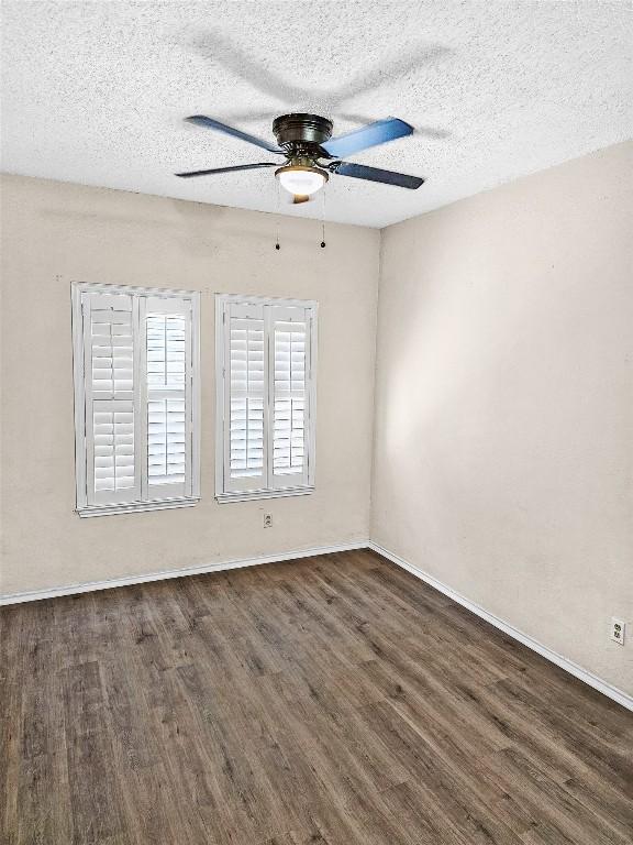 2706 Salado St Unit 205, Austin, TX 78705 - spare room featuring dark wood-type flooring, a ceiling fan, a textured ceiling, and baseboards