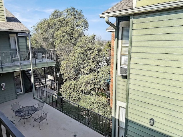 2706 Salado St Unit 205, Austin, TX 78705 - view of side of home featuring stairs, roof with shingles, and a patio area