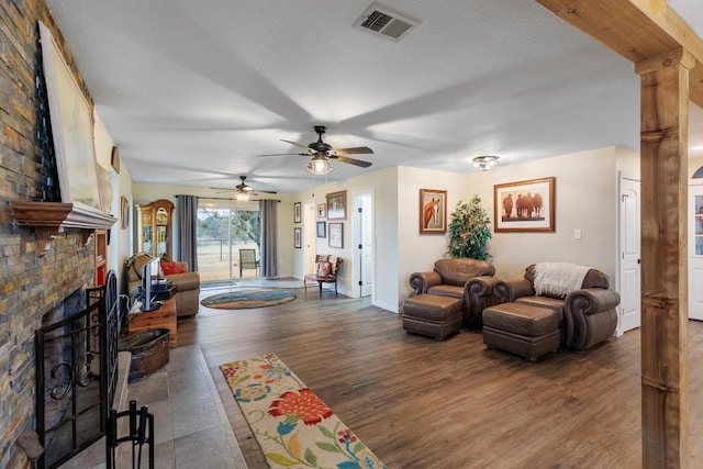 2340 E State Highway 71, Llano, TX 78643 - living room with a ceiling fan, wood finished floors, and a brick fireplace