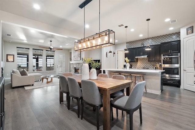 225 Escarpment Way, Cedar Park, TX 78613 - dining area featuring ceiling fan, wood finished floors, recessed lighting, and a fireplace