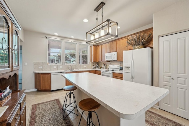 1261 Nevarez, Kyle, TX 78640 - kitchen with white appliances, decorative backsplash, a kitchen breakfast bar, light countertops, and recessed lighting