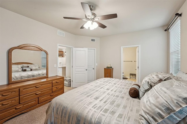 1261 Nevarez, Kyle, TX 78640 - bedroom featuring light carpet, a ceiling fan, and connected bathroom