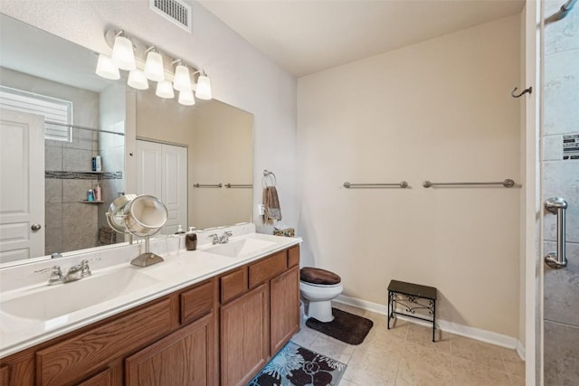 1261 Nevarez, Kyle, TX 78640 - bathroom featuring double vanity, tiled shower, and tile patterned flooring