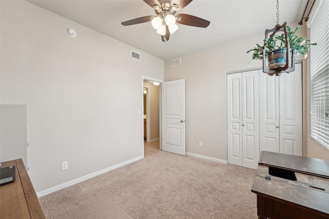 1261 Nevarez, Kyle, TX 78640 - unfurnished bedroom with light colored carpet, a closet, a ceiling fan, and multiple windows