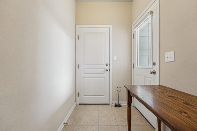 1261 Nevarez, Kyle, TX 78640 - doorway with baseboards and light tile patterned flooring