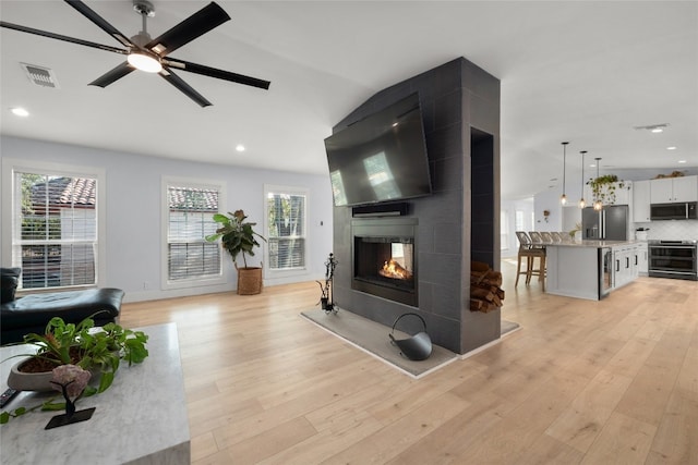 120 Acapulco Dr, Lakeway, TX 78734 - living area with a multi sided fireplace, light wood-style flooring, recessed lighting, ceiling fan, and lofted ceiling