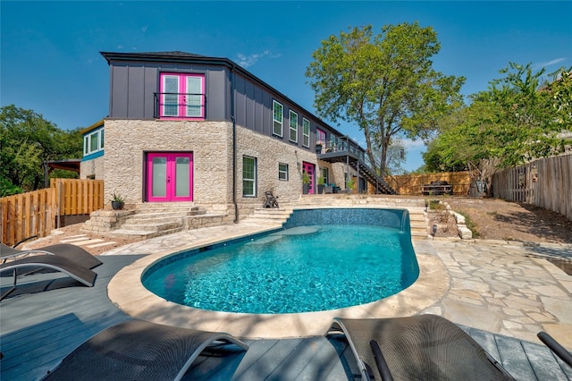 120 Acapulco Dr, Lakeway, TX 78734 - back of house with stone siding, a fenced backyard, stairs, board and batten siding, and a deck