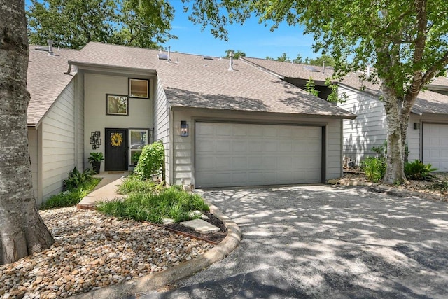 2114 Goodrich Ave Unit 3, Austin, TX 78704 - view of front of house featuring roof with shingles, an attached garage, and driveway