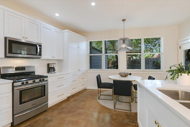 2114 Goodrich Ave Unit 3, Austin, TX 78704 - kitchen featuring appliances with stainless steel finishes, finished concrete floors, light countertops, white cabinets, and recessed lighting