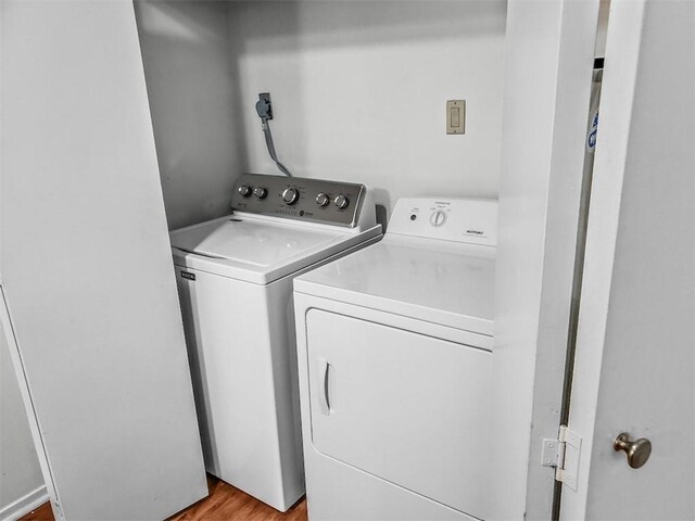 106 E 30th St Unit 305, Austin, TX 78705 - laundry area featuring separate washer and dryer and light wood-type flooring