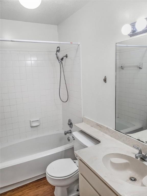 106 E 30th St Unit 305, Austin, TX 78705 - bathroom featuring vanity,  shower combination, toilet, and wood finished floors