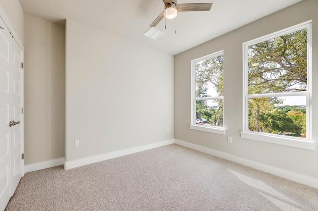21710 Patton Dr, Lago Vista, TX 78645 - spare room with light carpet, ceiling fan, and baseboards