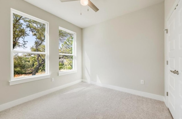 21710 Patton Dr, Lago Vista, TX 78645 - spare room featuring light carpet, ceiling fan, and baseboards