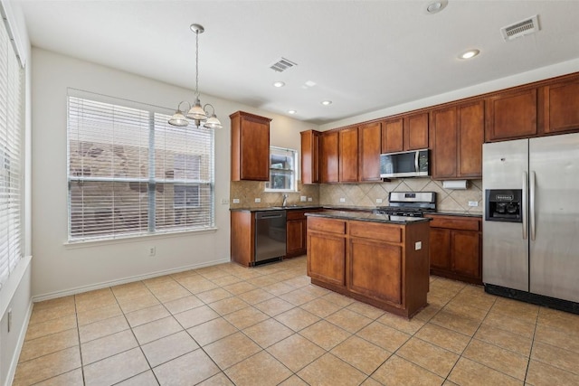 14009 Rountree Ranch Ln, Austin, TX 78717 - kitchen with appliances with stainless steel finishes, dark countertops, backsplash, a chandelier, and recessed lighting