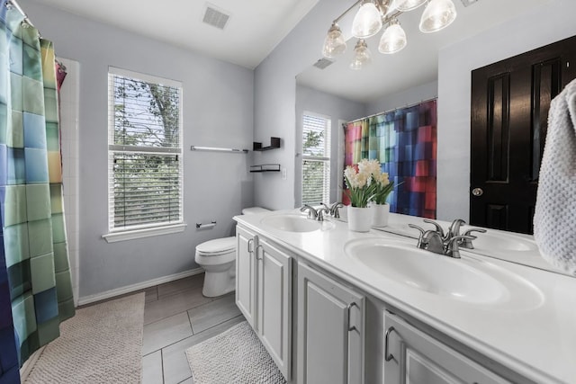 1600 Serenity Springs Cv, Cedar Park, TX 78613 - full bathroom featuring double vanity, toilet, baseboards, tile patterned floors, and a shower with shower curtain